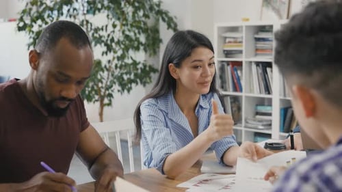 Diverse Team Collaborating on Project in Modern Office