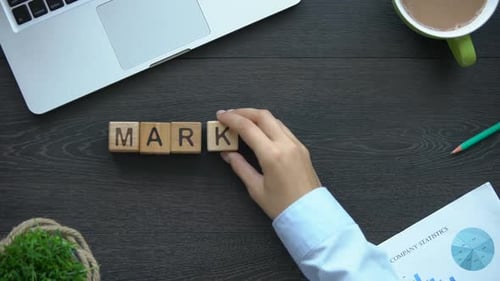Marketing Spelled Out With Wooden Blocks on Desk