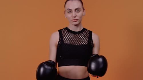 Woman in Boxing Gloves Stands Ready