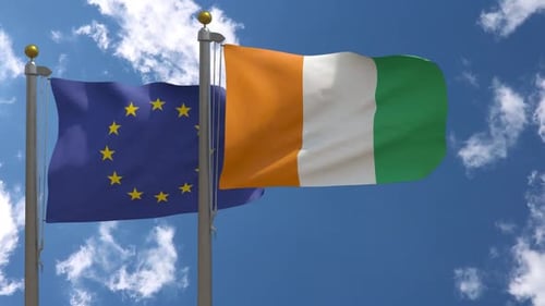 European Union and Côte d'Ivoire Flags Waving in Blue Sky