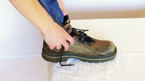 Tying the Laces on a Brown Leather Boot