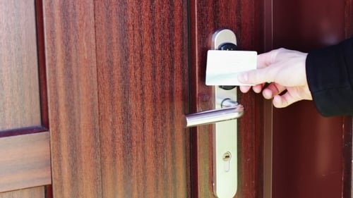 The Man Opens The Door To An Electronic Key - Card