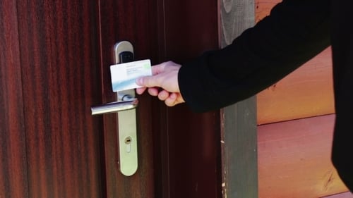 The Man Opens The Door To An Electronic Key - Card