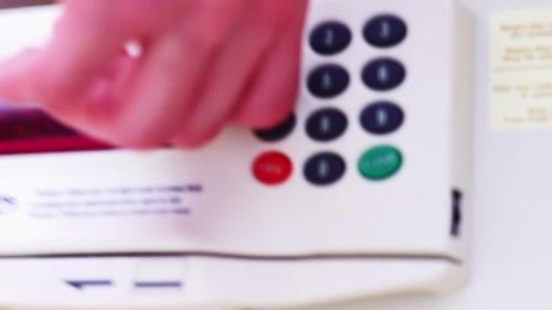 Hand Enters Code on Digital Home Safe Keypad