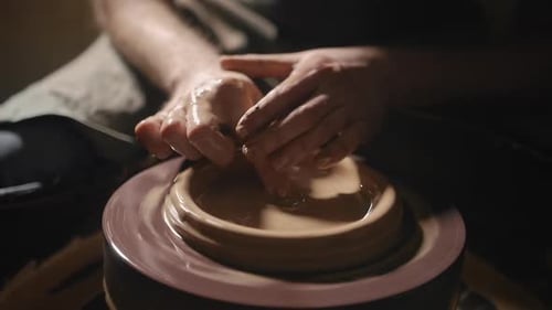Hands Shaping Clay on Spinning Pottery Wheel