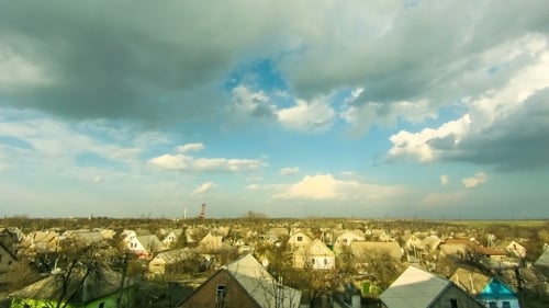 Time Lapse of Clouds Over Rural Village