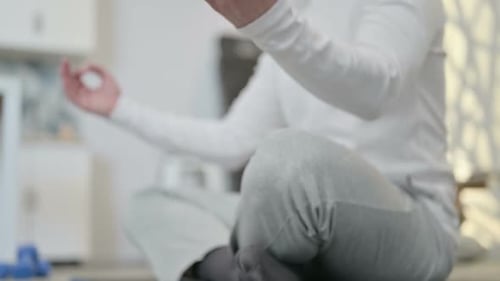Man Meditating in Yoga Pose at Home