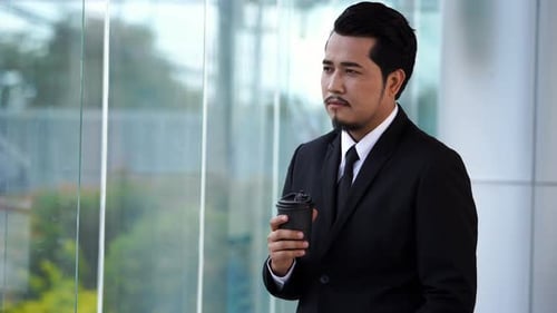 young business man thinking and drinking coffee in office