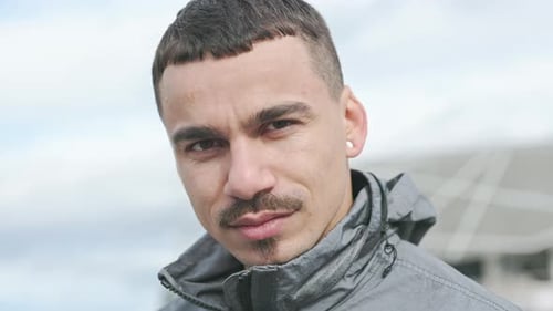 Face Of Young Man On The Street. Handsome Guy With Mustache.