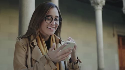 Student Reading Good News on Phone