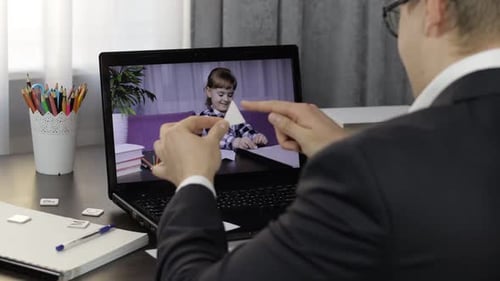 Adult Tutoring Child in Online Lesson
