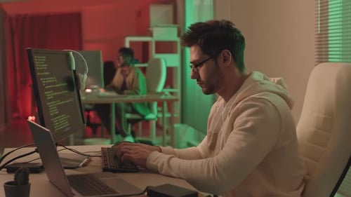 Serious Programmer Working in Office