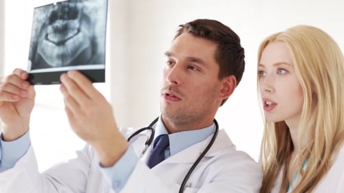 Two Doctors Discussing X-ray Image At Hospital