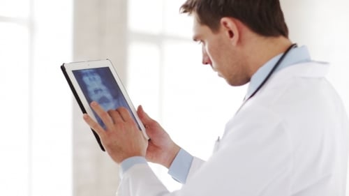 Doctor With X-ray Scan On Tablet Pc