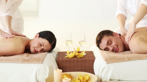 Happy Couple Having Massage At Spa Salon