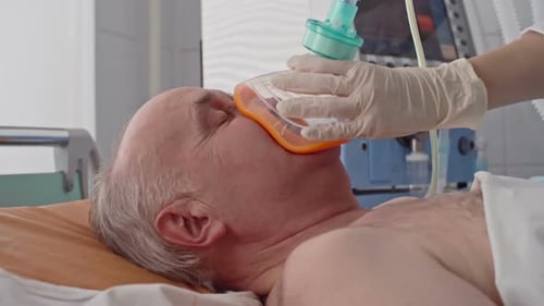 Male Patient Receives Oxygen in Hospital Room