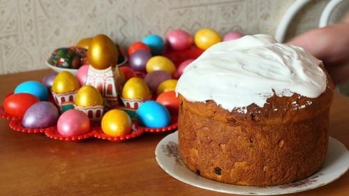 Decorating Easter Cake with Colorful Eggs and Icing