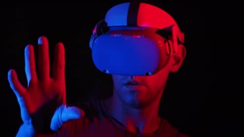 Young Adult Using VR Headset in Dark Room