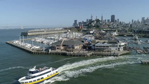 Aerial view of a boat sailing and the Pier 39