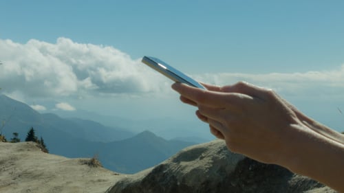Chatting On Mobile Phone At Mountain
