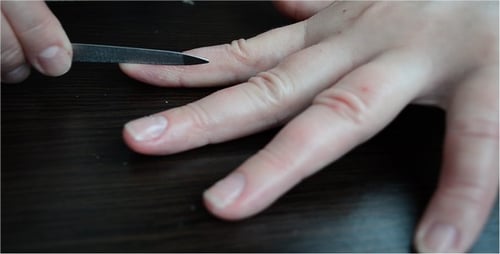 Knife Scrapes Fingernails for Manicure at Home