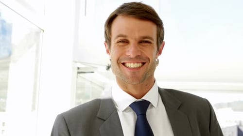 Smiling Businessman in Suit in Modern Office