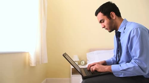 Man Working on Laptop at Home