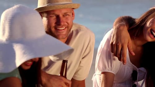 Friends Drinking Beer On The Beach