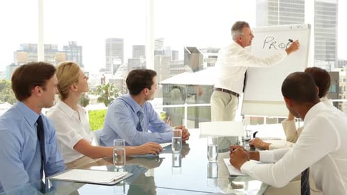 Businessman Writing Profit And Success On The Board At Presentation