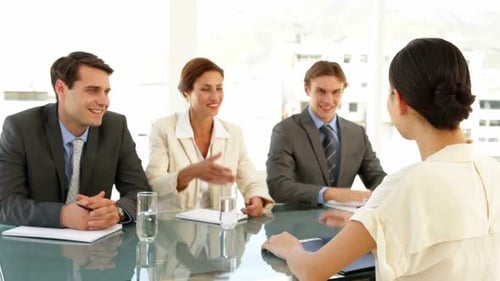 Adults Interviewing Job Candidate in Office Setting