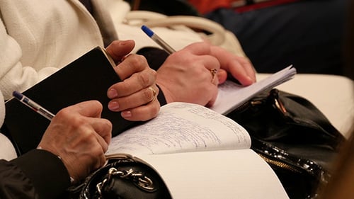 College Student Taking Notes While Studying