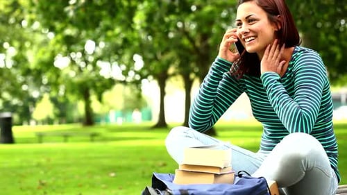 Pretty Student Talking On Phone On The Grass