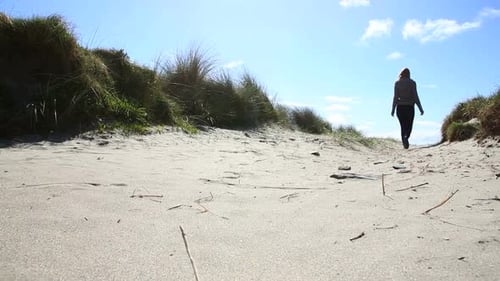 Blonde Woman Walking On The Beach