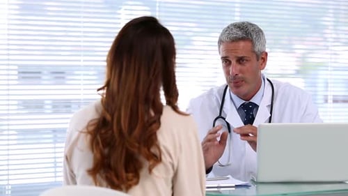 Doctor Discussing Health with Patient in Office