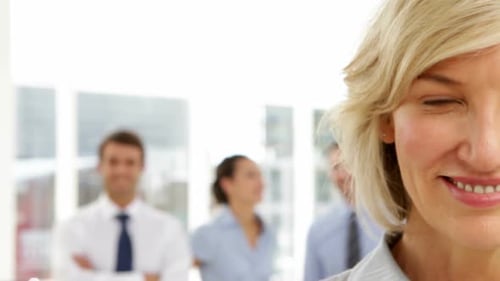 Smiling Businesswoman With Team in Modern Office