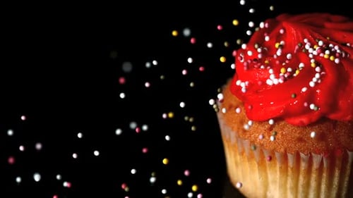 Cupcake with Red Frosting and Falling Sprinkles