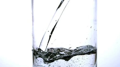 Water Pouring Into a Clear Glass