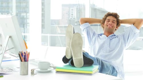 Man Relaxing with Feet Up in Modern Office