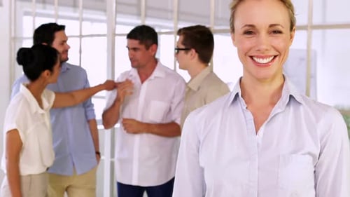 Smiling Businesswoman Gives Thumbs Up in Office