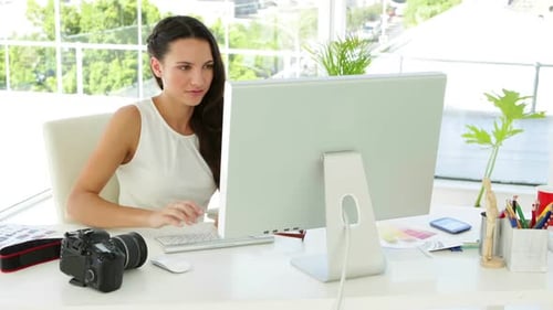 Woman Working on Computer at Bright Desk