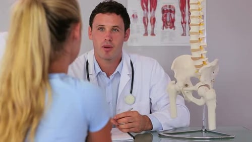 Doctor Explains Anatomy to Patient in Office
