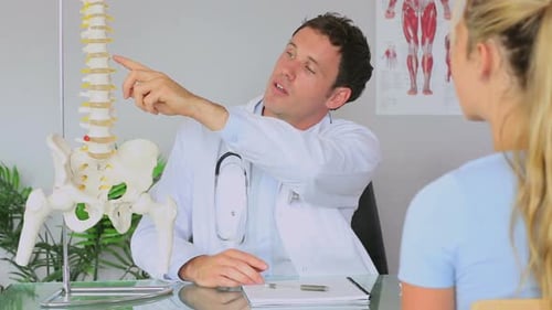 Doctor Explains Spine to Patient in Office