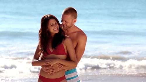 Loving Couple Embraces on a Sandy Beach
