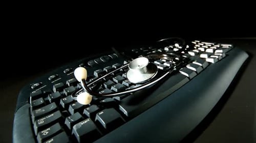 Stethoscope on Black Computer Keyboard