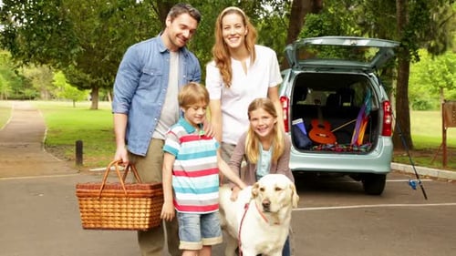 Family Smiles with Dog Before Park Picnic