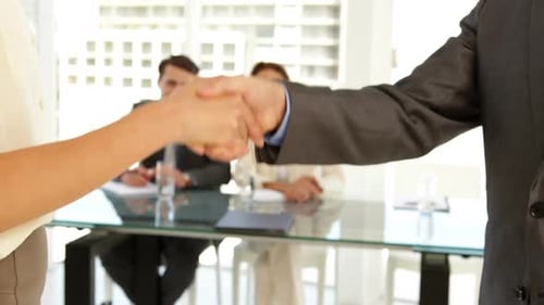 Business Handshake in Bright Modern Office