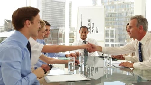 Business Team Meeting and Handshake in Modern Office