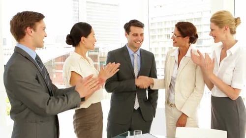 Business Team Congratulates Success in Modern Office