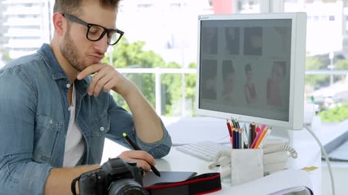 Photographer Using Graphics Tablet in Bright Office