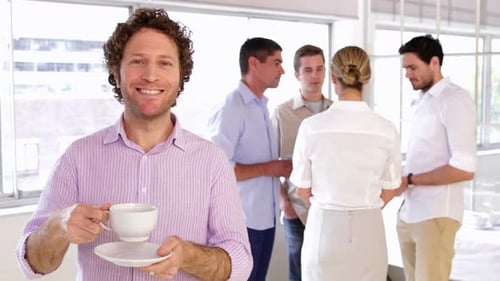 Coworkers Meeting in Bright Office with Coffee